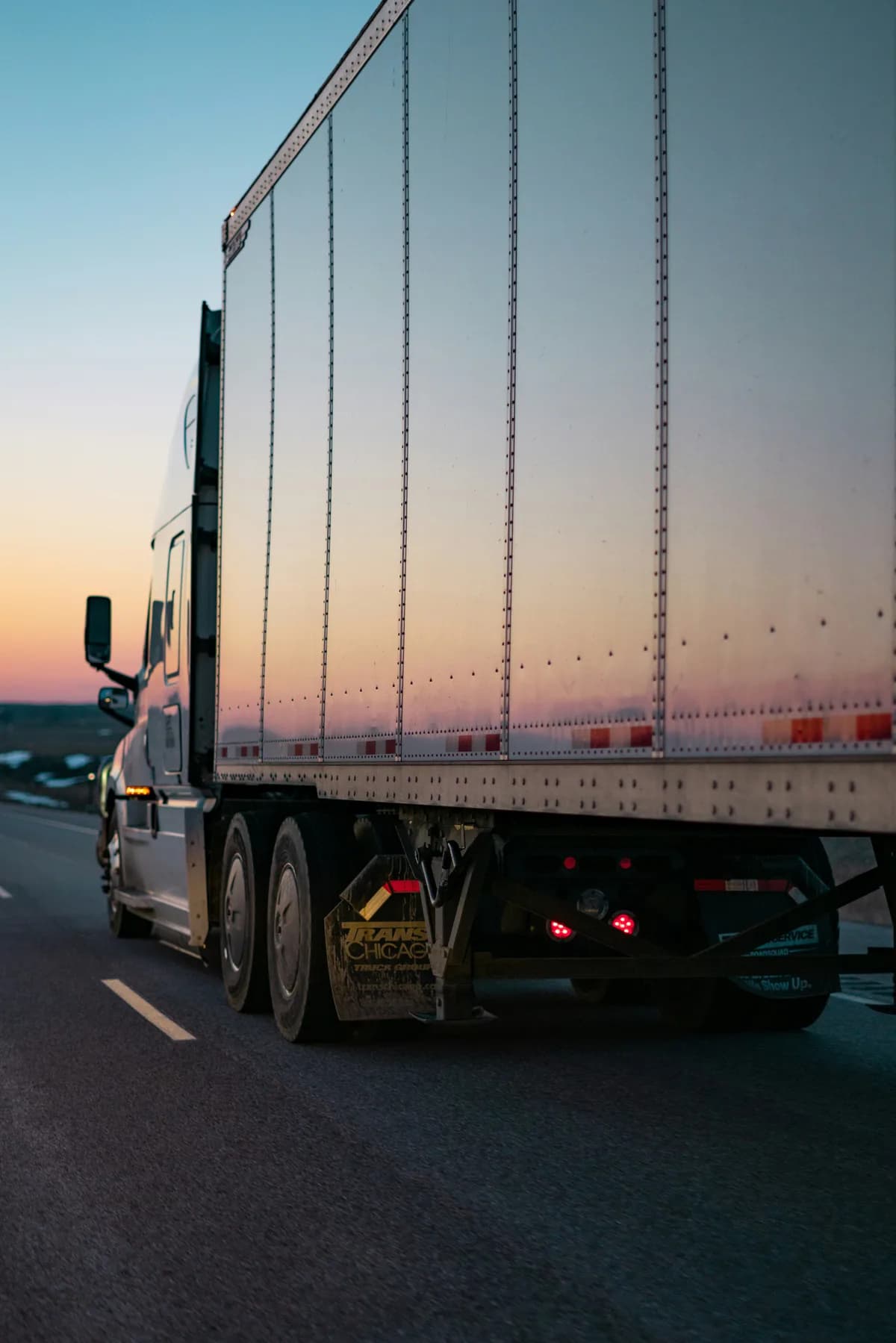 Truck driver standing beside a parked semi truck